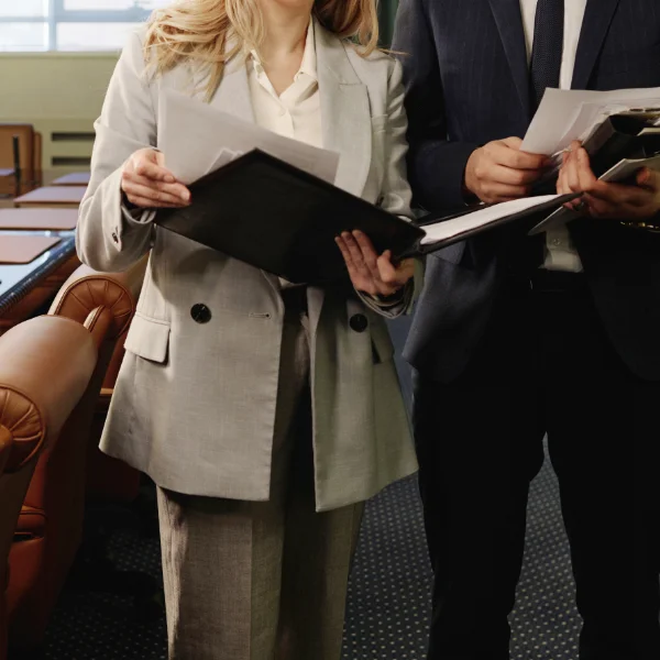 Attorneys Looking Through Documents in Spacious Boardroom